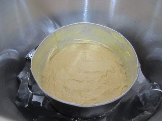 Cake batter in a baking pan in a pot